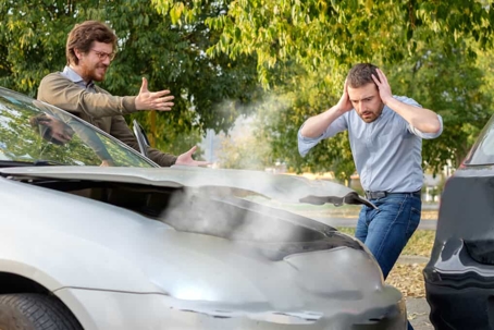 two people reacting after a car accident
