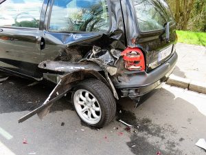 A car that has been hit on the back left tire